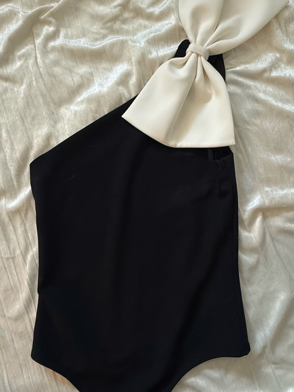 Express black One-Shoulder bodysuit with Cream Bow Accent